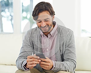 Whats up in the social media world. A handsome young man using his cellphone.