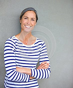 Whats your fountain of youth. Portrait of an attractive mature woman in casualwear standing against a gray wall.