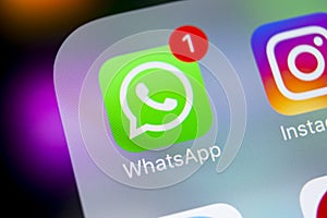 Whatsapp messenger application icon on Apple iPhone X smartphone screen close-up. Whatsapp messenger app icon. Social media icon.