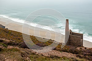 Wheal Coates mine surrounded by hills and the sea in Cornwall in the UK