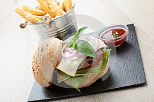 Wheat beef sandwich hamburger, fried potatoes, ketchup served for launch