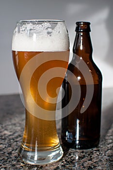 Wheat beer glass and brown bottle