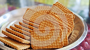 Wheat biscuits in the steel plate with blur background. Indian biscuits popularly known as Chai-biscuit in India