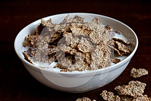 Wheat bran breakfast cereal in bowl.