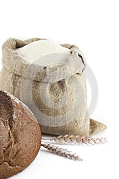 Wheat and bread with bag of flour