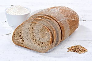 Wheat bread slice slices sliced loaf on wooden board