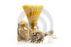 Wheat bunch, macaroni and pasta in jar, isolated on white background. Grain bouquet, golden spikelet.