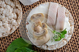 Wheat cakes with herring, champignons and greens