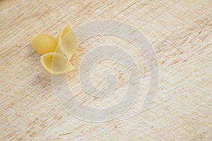 Wheat conchiglie pasta on cutting board