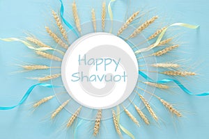 wheat crop on wooden table. Symbols of jewish holiday - Shavuot