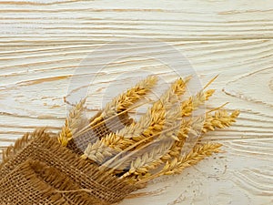 Wheat ear on wooden background frame photo