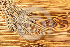 Wheat Ears on the Wooden Table.