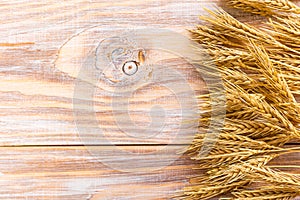 Wheat Ears on the Wooden Table. Sheaf of Wheat over Wood Background. Harvest concept