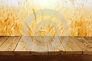 Wheat field background and empty wooden deck table