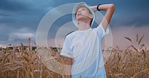 Wheat Field Reverie: Boy Gazing at Approaching Storm and Rainy Clouds in the Sky