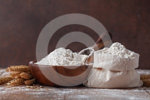 Wheat flour in cotton bag on wooden table. Ingredient for baking