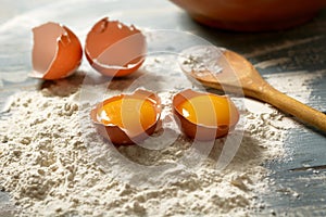 Wheat flour and eggs on wooden table - horizontal