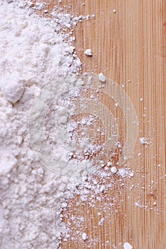 Wheat flour on wooden table representing cooking concept