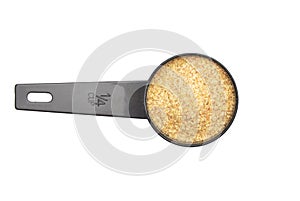 Wheat germs in measuring spoon on white background