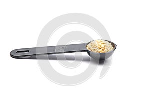 Wheat germs in measuring spoon on white background