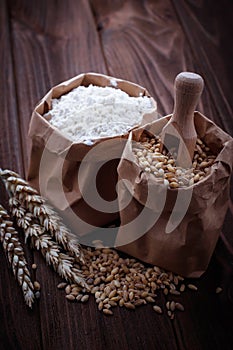 Wheat grain and flour in paper bags