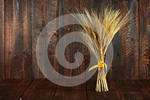 Wheat Grain Stalks on Grunge Wooden Background