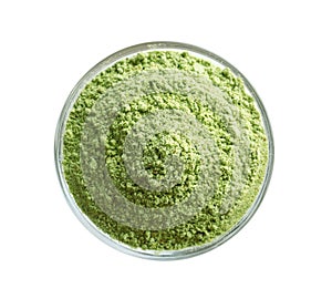 Wheat grass powder in bowl on white background