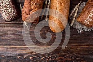 Wheat products on dark wooden. Bread and loaf. Carbohydrates.