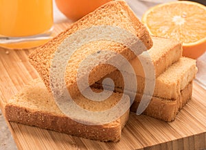 Wheat rusk in a wooden panel with orange