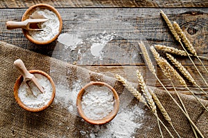 Wheat and rye ear for flour production on wooden desk background top view