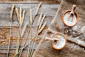 Wheat and rye ear for flour production on wooden desk background top view