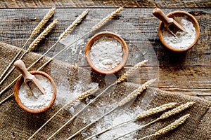 Wheat and rye ear for flour production on wooden desk background top view