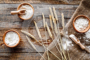 Wheat and rye ear for flour production on wooden desk background top view