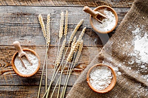 Wheat and rye ear for flour production on wooden desk background top view