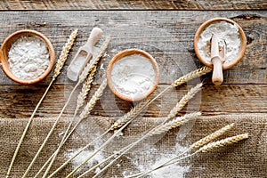 Wheat and rye ear for flour production on wooden desk background top view