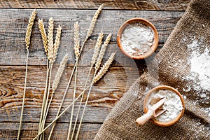 Wheat and rye ear for flour production on wooden desk background top view