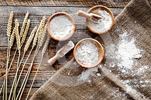 Wheat and rye ear for flour production on wooden desk background top view