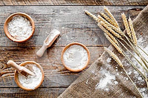 Wheat and rye ear for flour production on wooden desk background top view