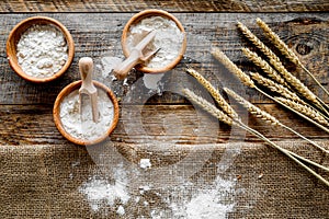 Wheat and rye ear for flour production on wooden desk background top view