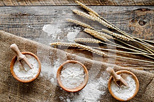 Wheat and rye ear for flour production on wooden desk background top view