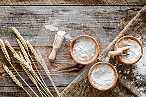 Wheat and rye ear for flour production on wooden desk background top view