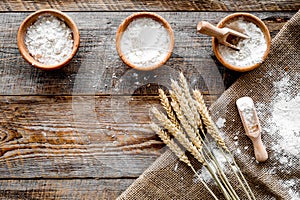 Wheat and rye ear for flour production on wooden desk background top view space for text