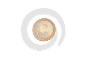 Wheat Semolina in wooden plate on white background, top view. Design element, copy space