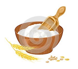 Wheat white flour in a wooden bowl, spoon and golden ears isolated.