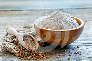 Wheat wholemeal flour in a wooden bowl.