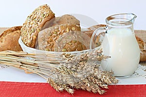 Wheats sticks, `fresh bread and milk on white background.