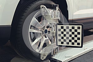 Wheel alignment equipment on a car wheel in a repair station