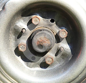 Wheel or automobile disk. View of a gray or silver rim of a car. Fragment of the central part (axle) of an old wheel