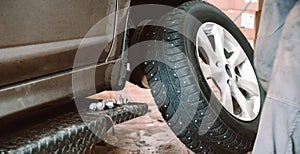 Wheel balancing or repair and change car tire at auto service garage or workshop by mechanic