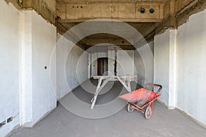 Wheel barrow and scaffolding at construction site